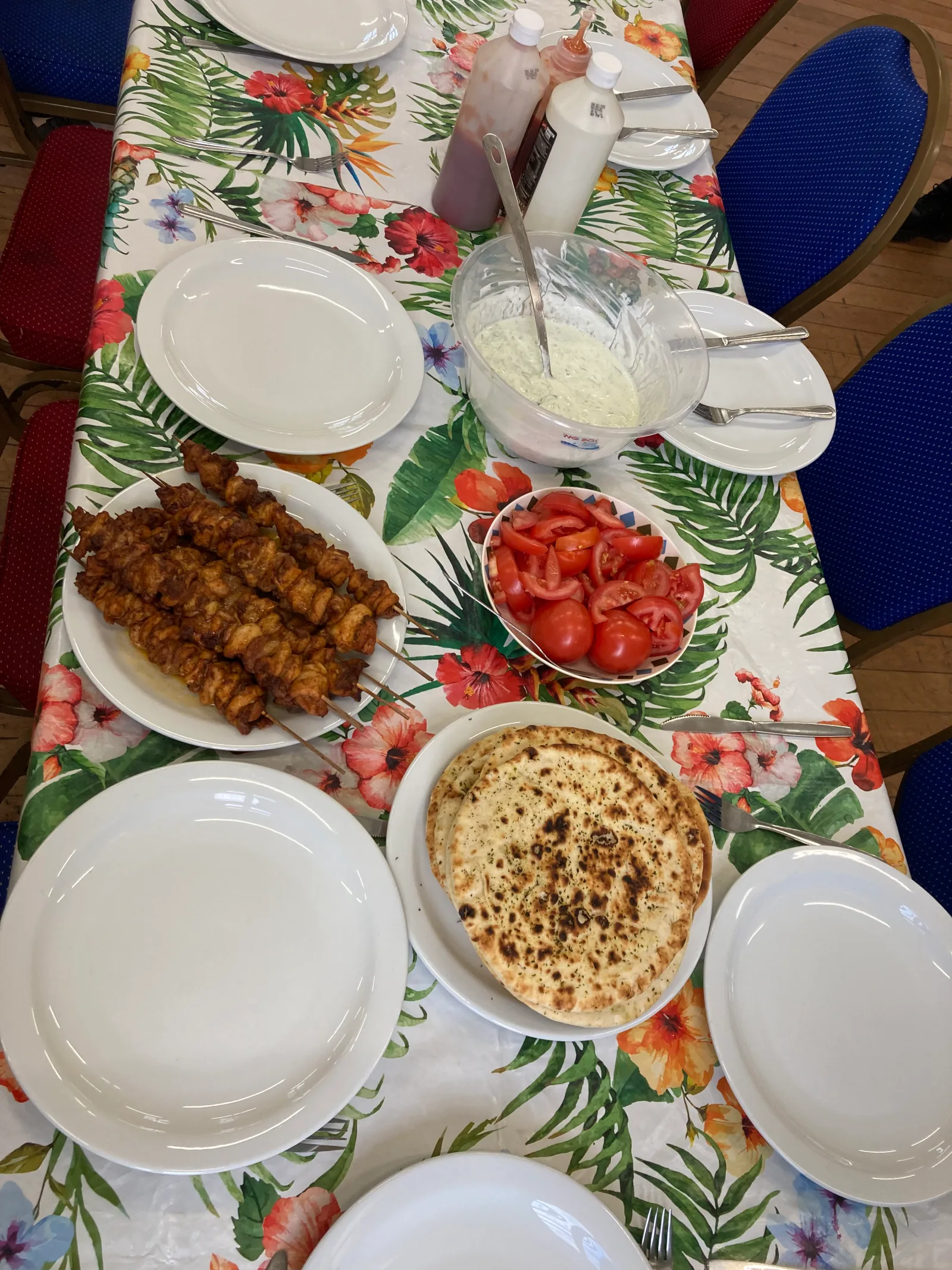 A colourful shared cooking table at a Kinship Kitchen Cook and Chill session